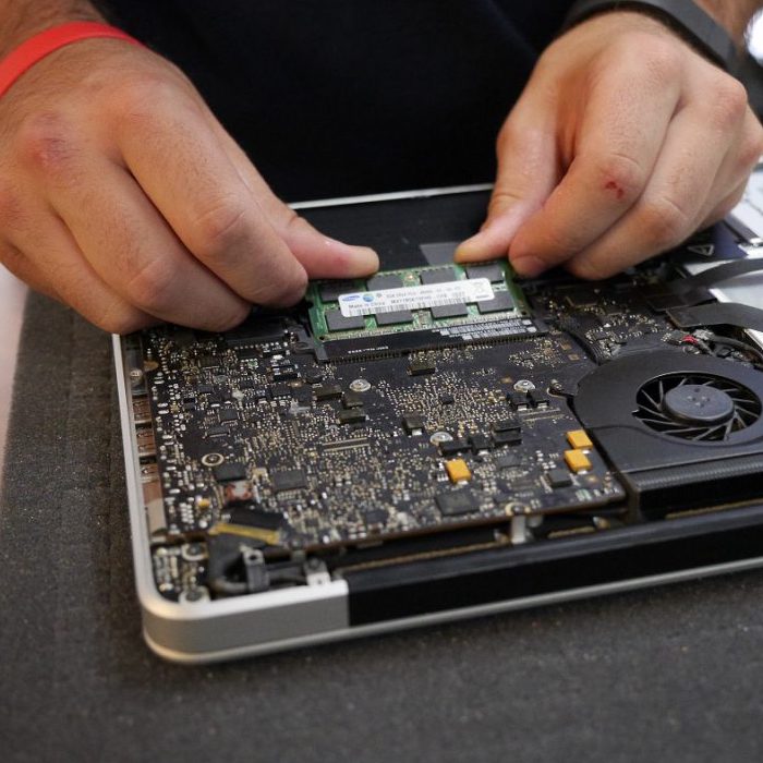 An ABC Computers Plus technician diagnosing a device